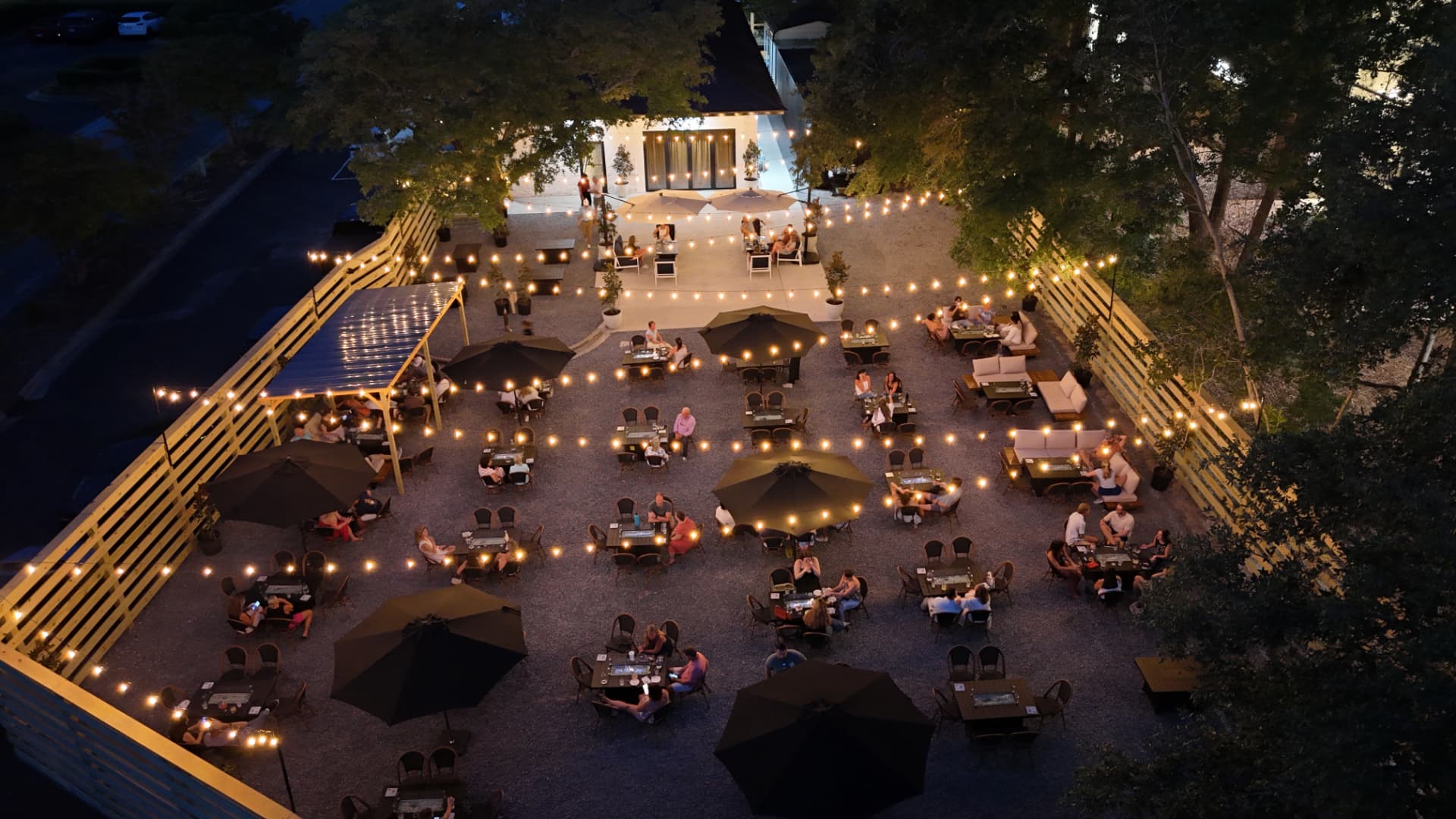 String-lit patio full of guests at Porter's Neck